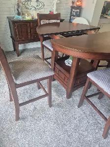 kithen table with chairs and hutch.