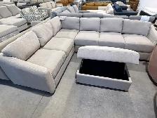 Grey fabric sectional with storage ottoman