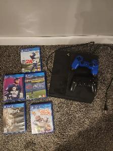 PS4 console with games and 2 controllers.