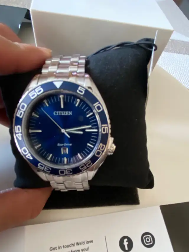 Brand new men’s Citizen Eco Drive blue dial 42 mm. $300.l