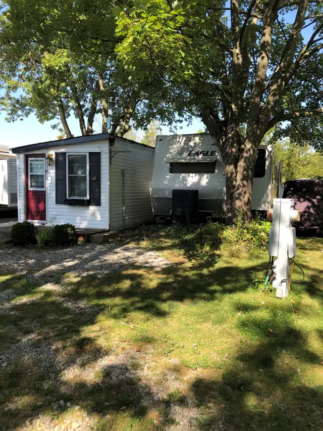 Trailer parked with deck and add room sleeps 9-Lake Erie 49K