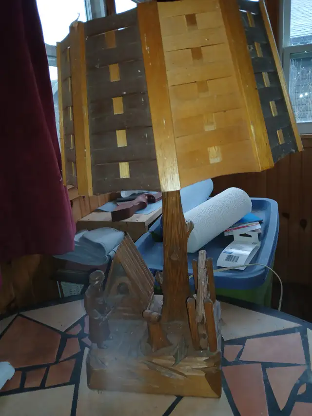 Old carved wooden lamp of a Baker baking bread