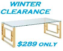 EROS COFFEE TABLE IN POLISHED GOLD AND THICK GLASS..