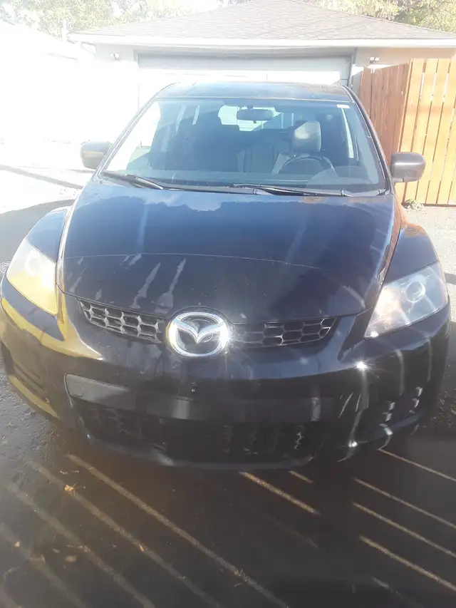 2009 Mazda CX-7 AWD active 175,000 km $5,000$.