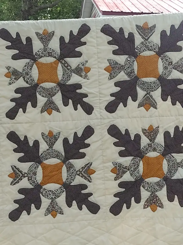 Peach coloured quilt with flowers 75 x 92