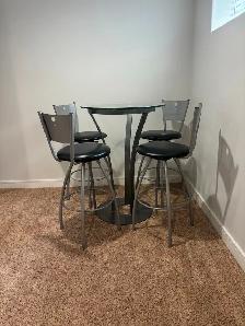 Bar style round glass top table with 4 stools for sale