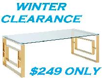 EROS COFFEE TABLE IN POLISHED GOLD AND THICK GLASS..