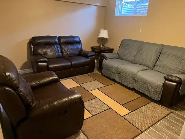 Dark brown leather recliner couch and love & chair seat. Used In