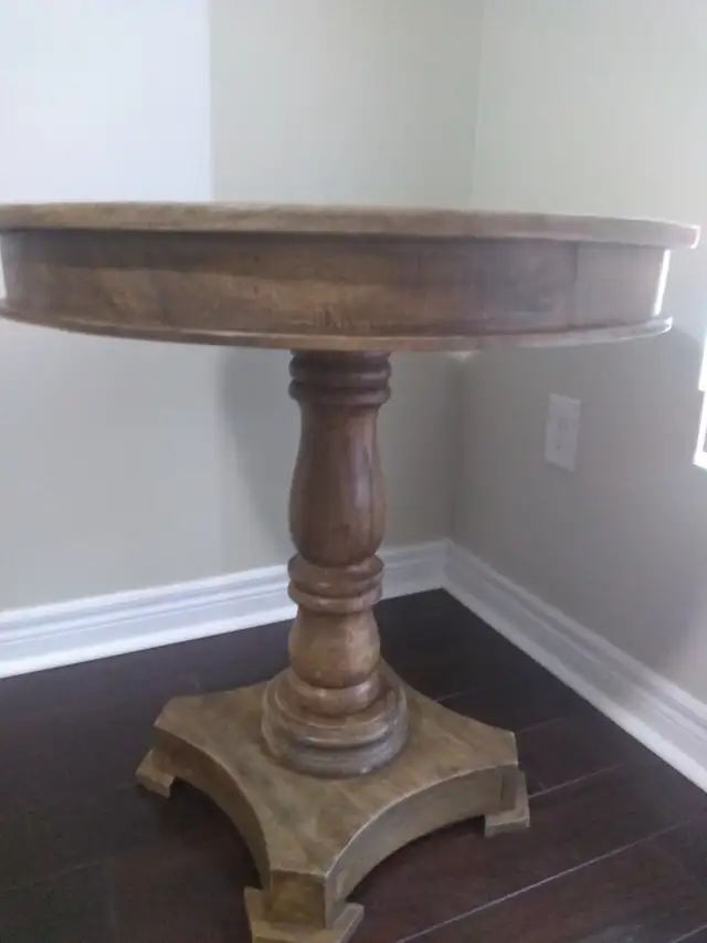 Solid wood dining table with two upholstered grey chairs