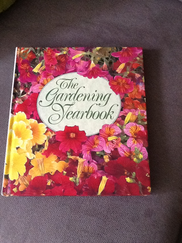 THE GARDENING YEARBOOK and one pair of gardening gloves