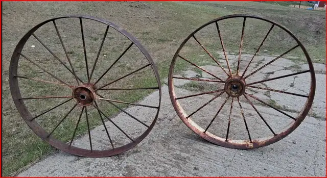 Two Vintage Antique Steel Wheels.  Four feet tall.
