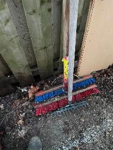 2 brooms and a claw rake