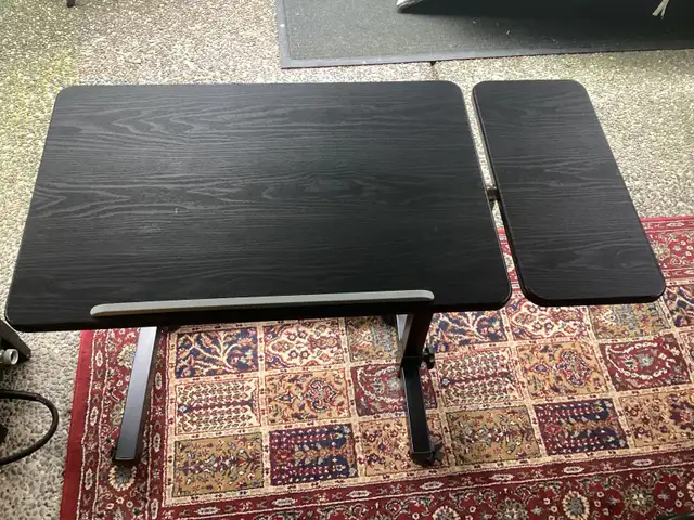 Height adjustable table on wheels with locking brakes