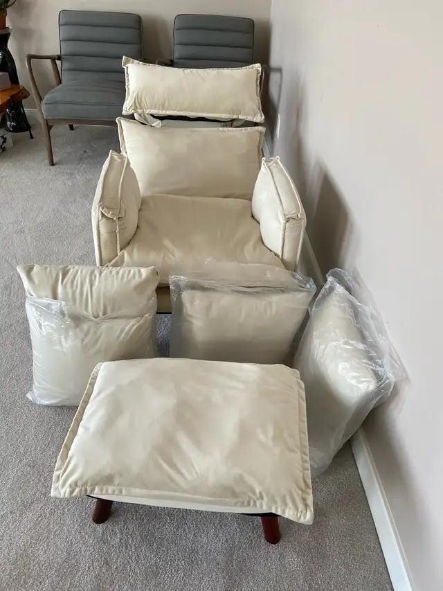 Cream fabric reclining arm chair $250.  Ottoman, 4 pillows
