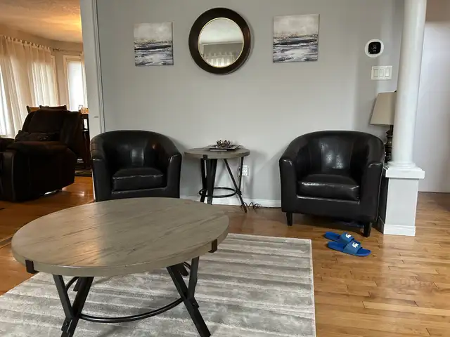 living room set with four dark brown chairs