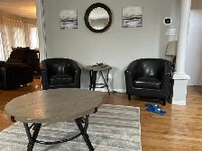 living room set with four dark brown chairs