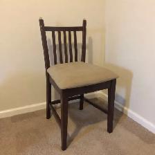 Slat-back beige swayed wood chair