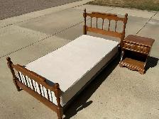 Single maple bed and night table.