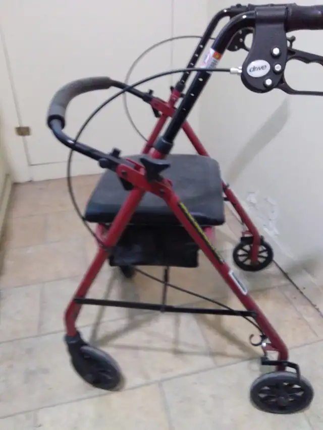 New four wheeled walker with brakes and seat with storage - Photo 4