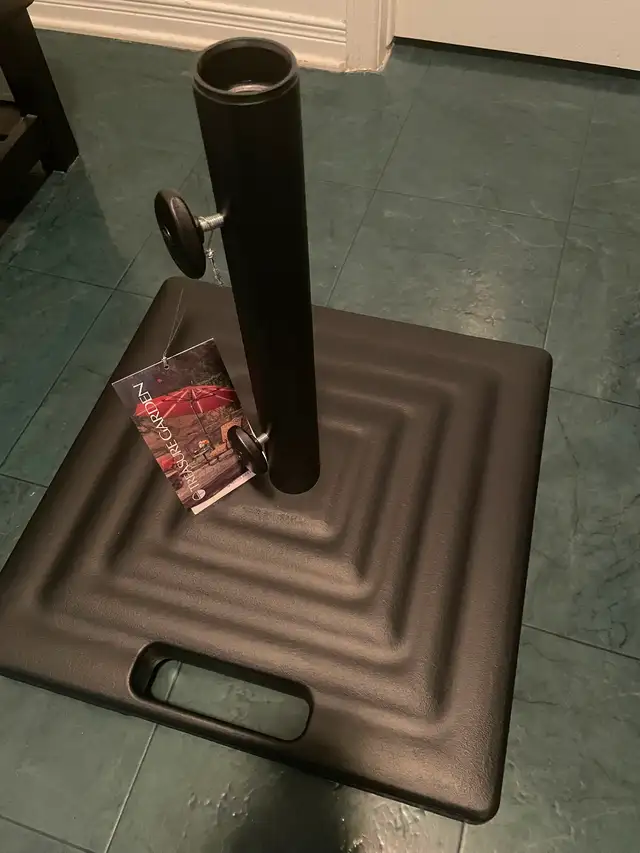 Brand New Treasure Garden 100lb metal umbrella stand on wheels