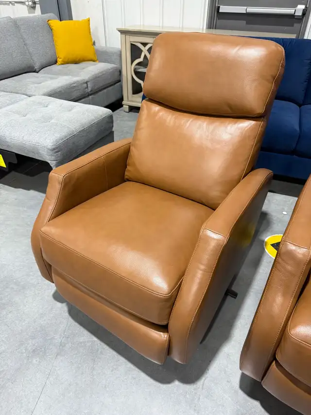 Tan leather swivel pushback recliner