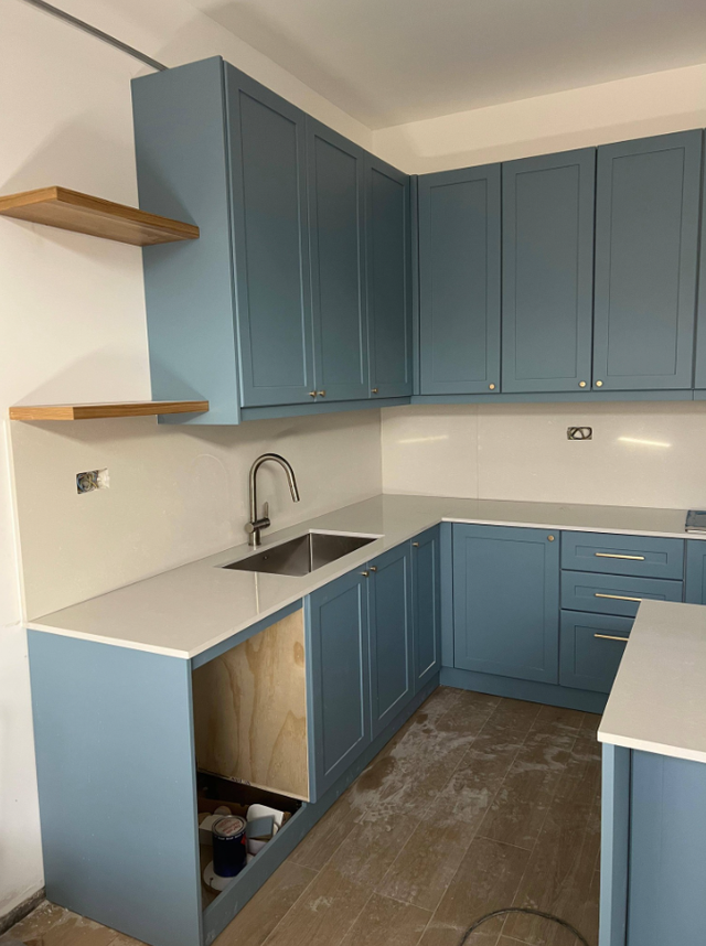 Plain White Countertop With Beautiful Blue Island