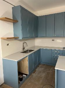 Plain White Countertop With Beautiful Blue Island