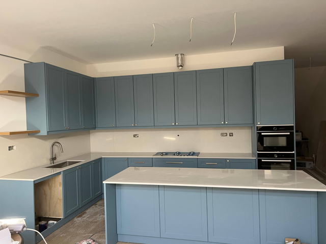 Plain White Countertop With Beautiful Blue Island - Photo 2