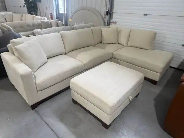 Cream fabric sectional with storage ottoman
