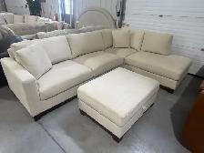 Cream fabric sectional with storage ottoman