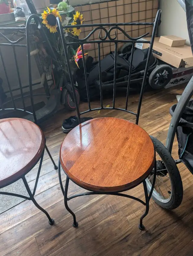 2 wrought iron chairs with beautiful wood seats