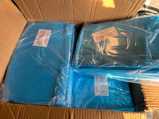 NEW ONE CASE OF (100) BLUE ISOLATION GOWNSAS PICTURED