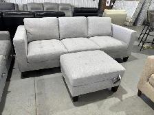 Light grey fabric sofa with matching ottoman