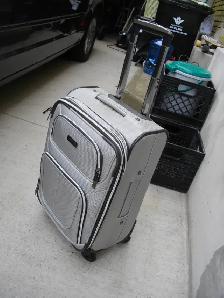 nice silver carry on suit case with swivel wheels