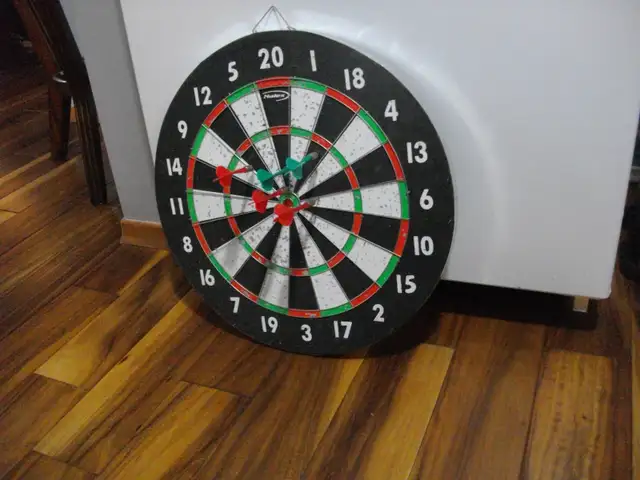dart board with a few darts