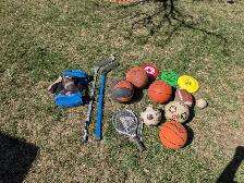Assorted basket balls, footballs, hockey sticks, racquet etc.