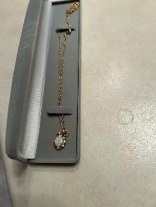 Woman’s gold necklace with large Opal & 10 Diamonds