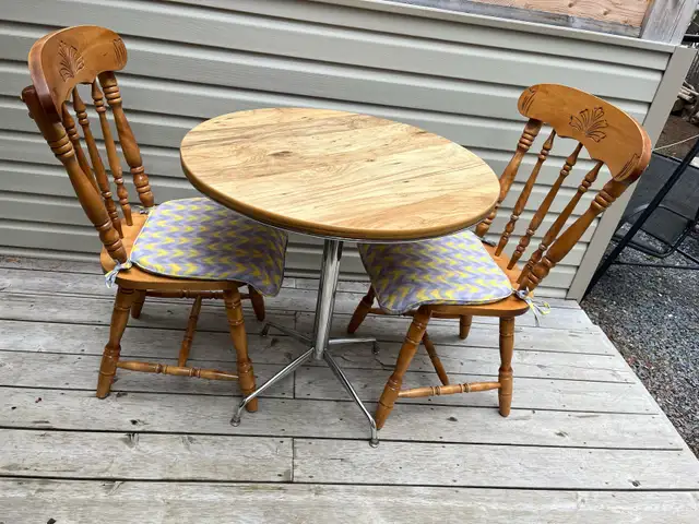 small kitchen table and two wooden chairs
