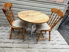 small kitchen table and two wooden chairs