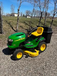 John Deere mower with grass bagger.