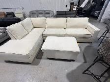 Cream fabric sectional with storage ottoman
