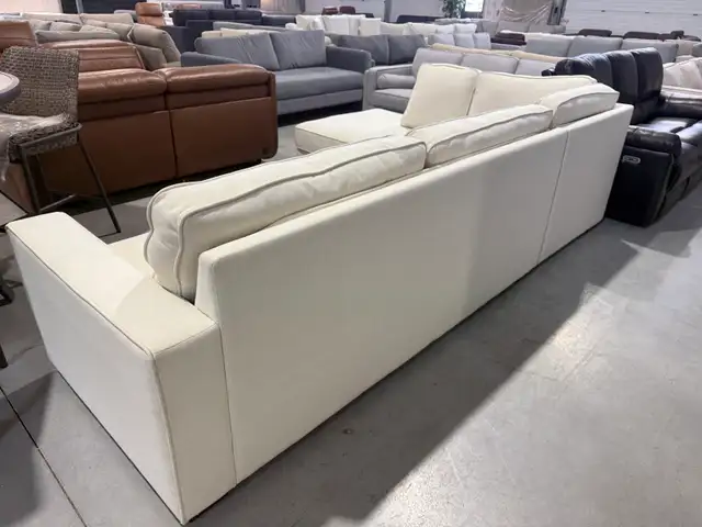 Cream fabric sectional with storage ottoman - Photo 3
