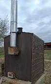 Homesteader Off-Grid Outdoor Wood Burning Furnace.