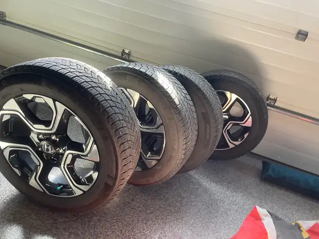 Michelin X Ice winter tires with rims.