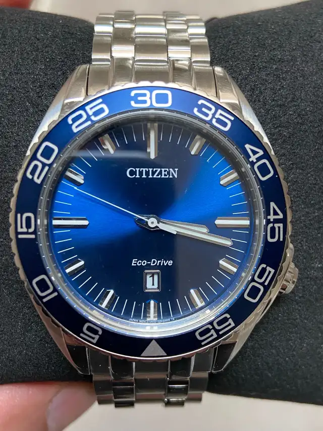 Brand new men’s Citizen Eco Drive blue dial 42 mm. $300.