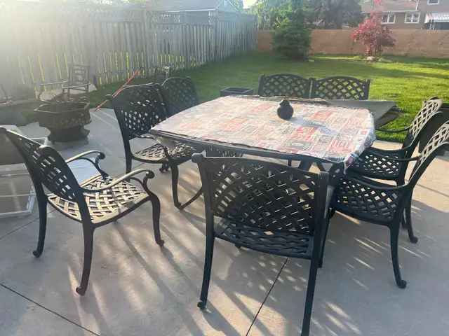 8 seats wrought iron patio table with seat cushions  …… $700.00