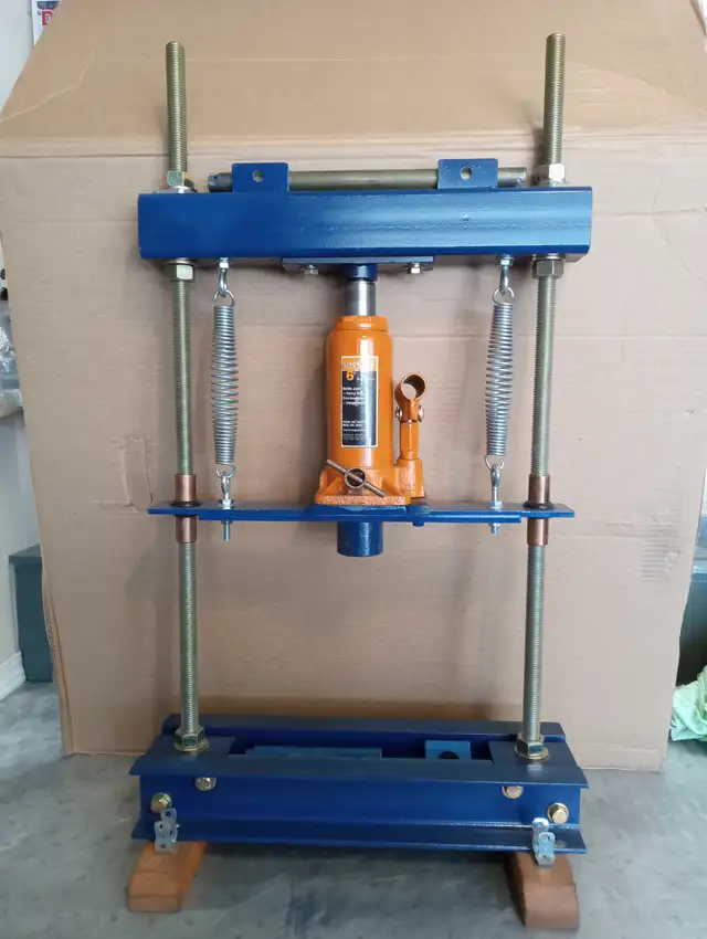 Hydraulic shop press (bench top) with 6-ton bottle jack.