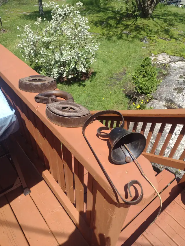 2 sad irons one handle and metal bell
