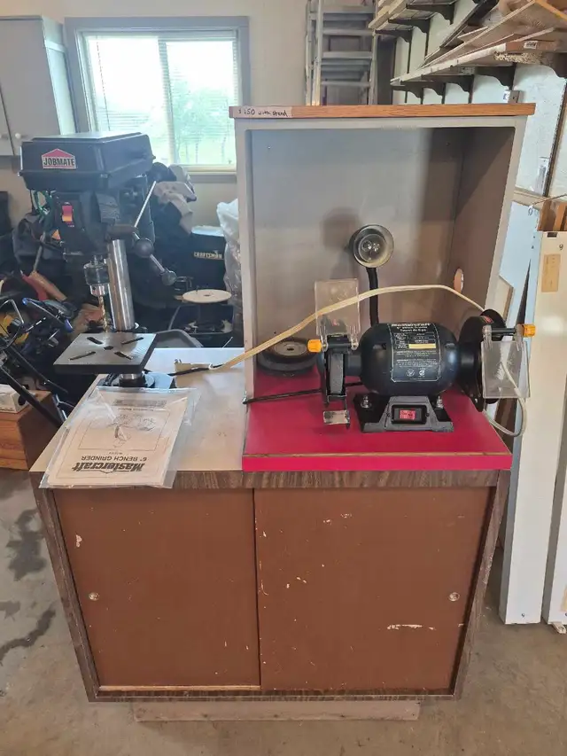 Bench grinder and drill press counter on cabinet