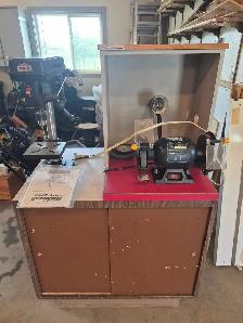Bench grinder and drill press counter on cabinet